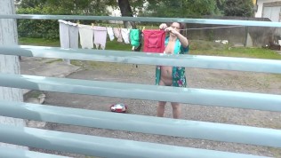 Neighbor in bathrobe without panties and bra dries washing courtyard, neighbour watching out window